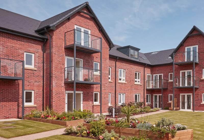 Block of retirement flats overlooking gardens